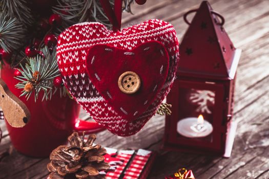 Christmas decorations: heart, candlestick and sleds on old wooden table