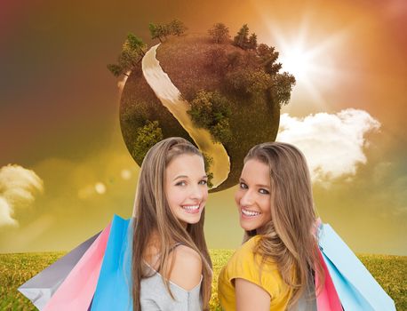 Composite image of two young women with shopping bags 