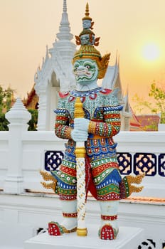 Thai traditional titan sculpture with sunset sky