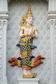 Thai traditional angel stucco on wall in Buddhist temple