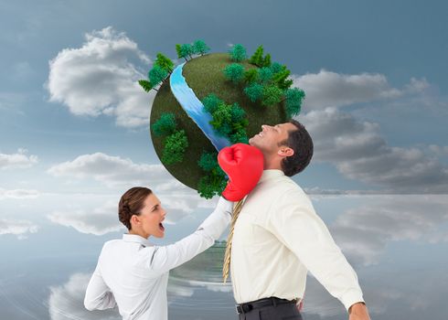 Composite image of businesswoman hitting a businessman with boxing gloves