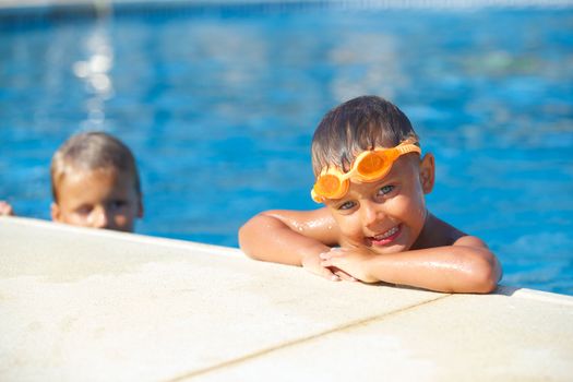 Activities on the pool. Cute boy in swimming pool