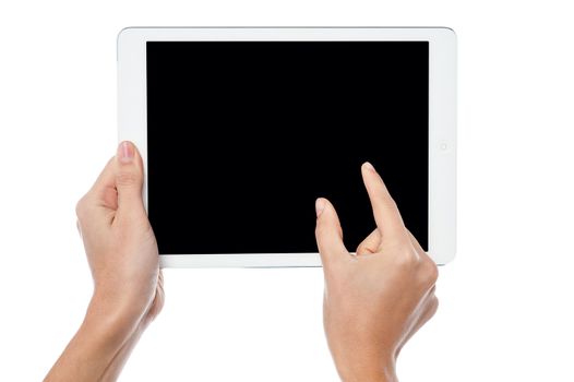 Womans fingers pointing on tablet screen