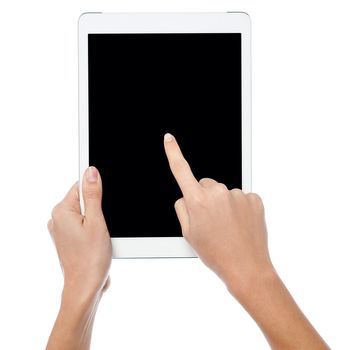 Womans finger pointing on tablet screen