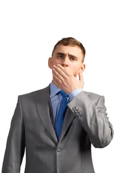 Portrait of a tired young businessman yawning behind her hand, isolated on white background