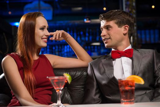 Young couple talking in a nightclub, have fun