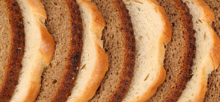 Sliced white and brown loaf of bread. Whole background.