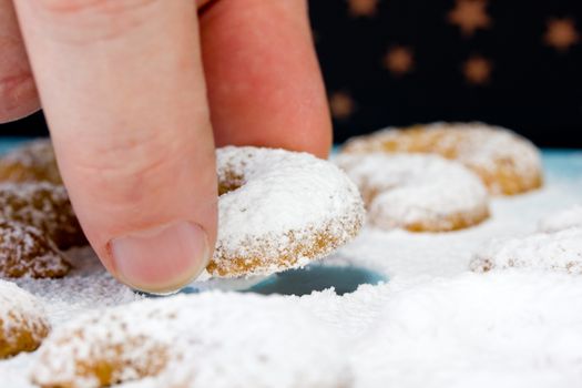 Caucasian person eating some vanillekipferl