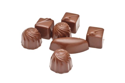 Chocolate pralines on white background