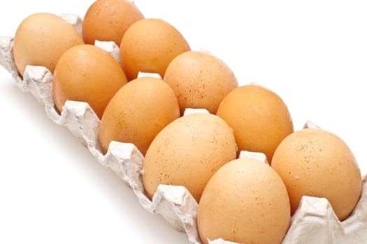 Brown eggs in a carton package on white background