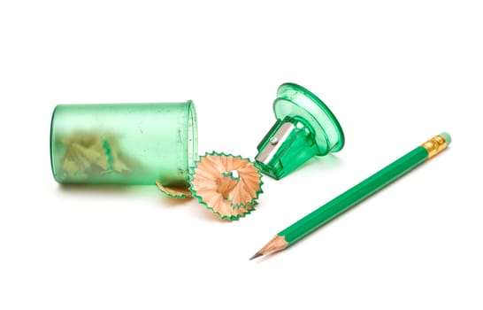 Green sharpener and pencil on white background.