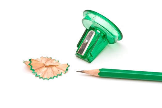 Green sharpener and pencil on white background.