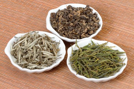 Chinese teas in plates on bamboo mat