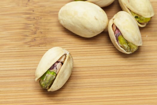 Pistachio nuts on wooden board