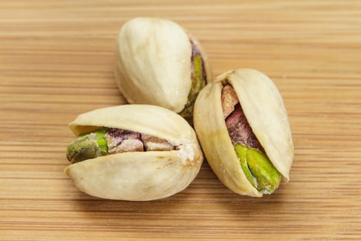 Pistachio nuts on wooden board