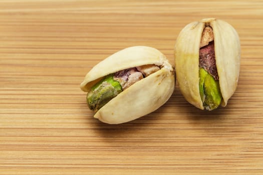 Pistachio nuts on wooden board