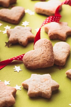 Christmas cookies with red ribbon on green