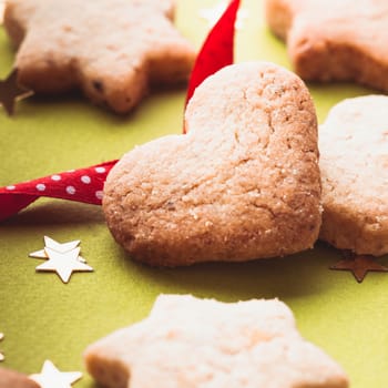 Christmas cookies with red ribbon on green