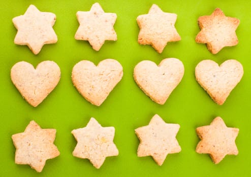 Holiday cookies as a background pattern on green