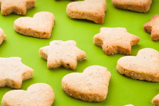 Holiday cookies as a background pattern on green