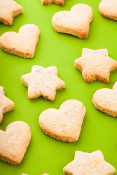 Holiday cookies as a background pattern on green