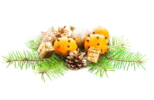 Christmas decorations - fir, tangerins and gold presents on white