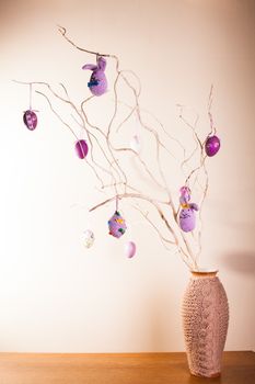 Handmade crochet easter decorations on the branches in vase