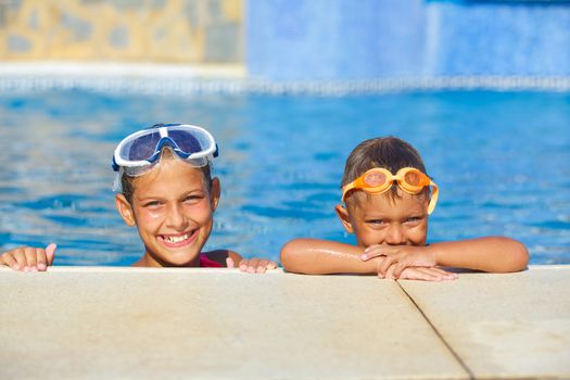 Activities on the pool. Cute kids in swimming pool