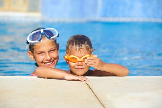 Activities on the pool. Cute kids in swimming pool