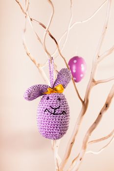 Handmade crochet easter decorations on the branches - bunny egg