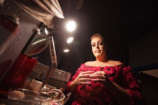 Man in backstage dressing up as a woman