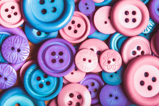 A lot of pink and purple sewing buttons closeup