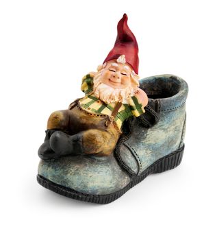 Gnome sitting on a boot isolated with clipping path 