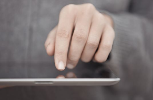 Woman with digital tablet surfing the web. Close-up view