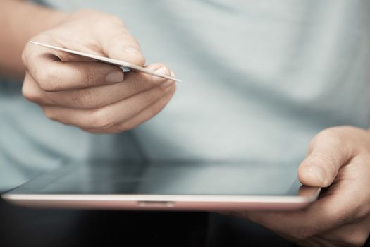 Human hands with digital tablet and credit card