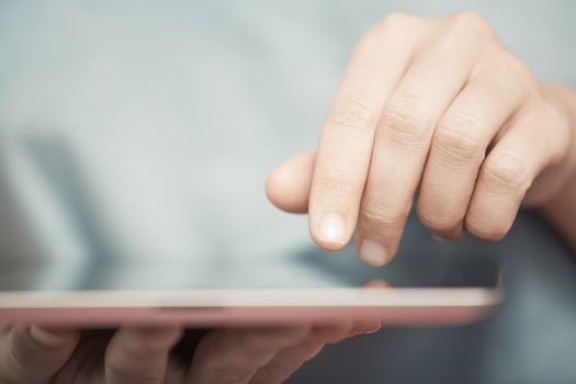 Human hands working with digital tablet