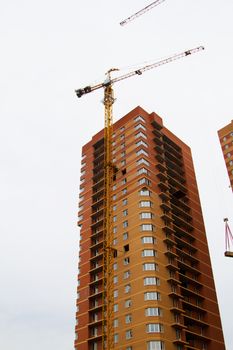 High rise construction. Brick houses under construction.