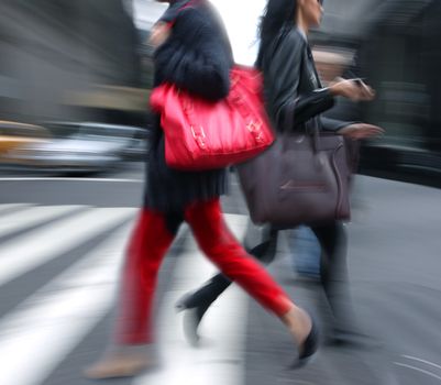 Young people at rush hour walking in the street. Intentional motion blur