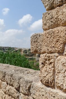 Ancient weathered stone wall in Nahal Taninim archeological park in Israel