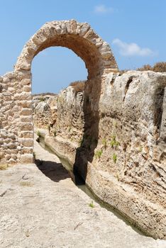 Ancient irrigation ditch and arch in Nahal Taninim archeological park in Israel