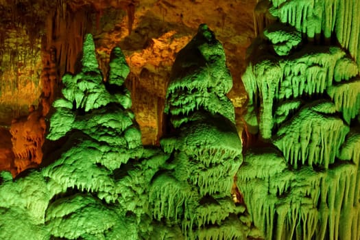 Strange green-lit stalagmite shapes in Soreq Cave, Israel