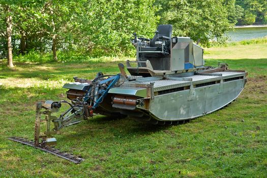 Amphibious vehicle with cutter trimmer for work in rivers and lakes                               