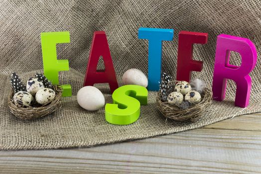 easter with letters on wooden table and jute background