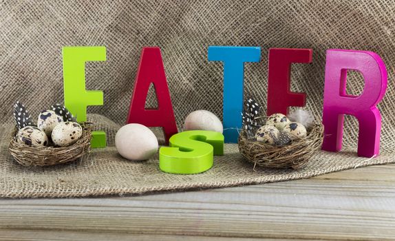 easter with letters on wooden table and jute background