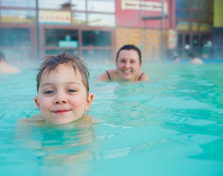 Activities on the pool. Cute boy swimming and playing in water in swimming pool