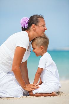 Mother and son having fun on tropical beach