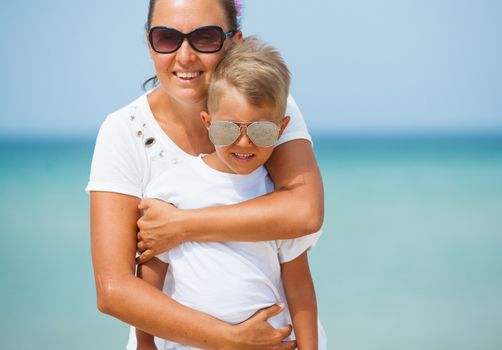 Mother and son having fun on tropical beach