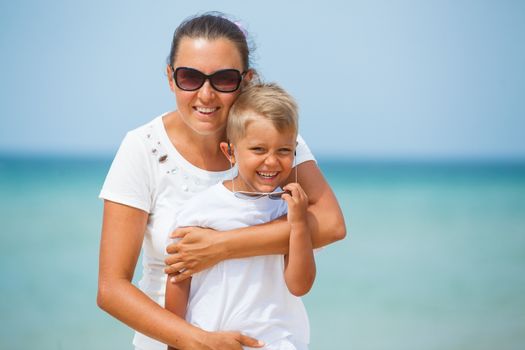 Mother and son having fun on tropical beach