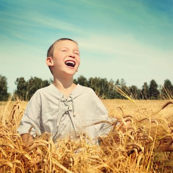 Vintage photo of Happy Kid in Wheat Field
