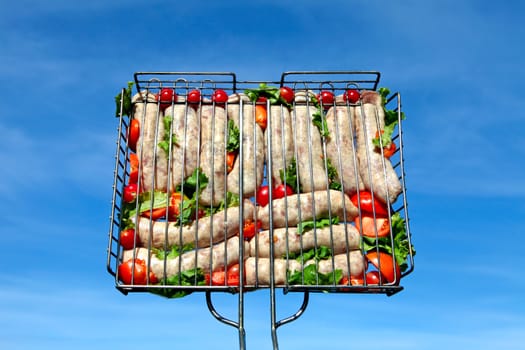 Sausage grill on the blue sky background